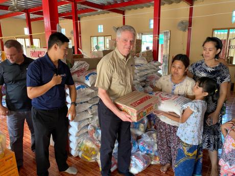 Rick Emenaker with Deeram Khong and Terry Fahey helping with with delivering supplies